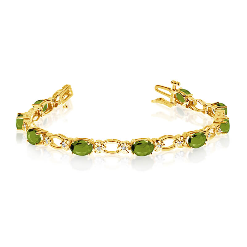 This 14k yellow gold natural peridot and diamond tennis bracelet features 12 oval peridots with a...