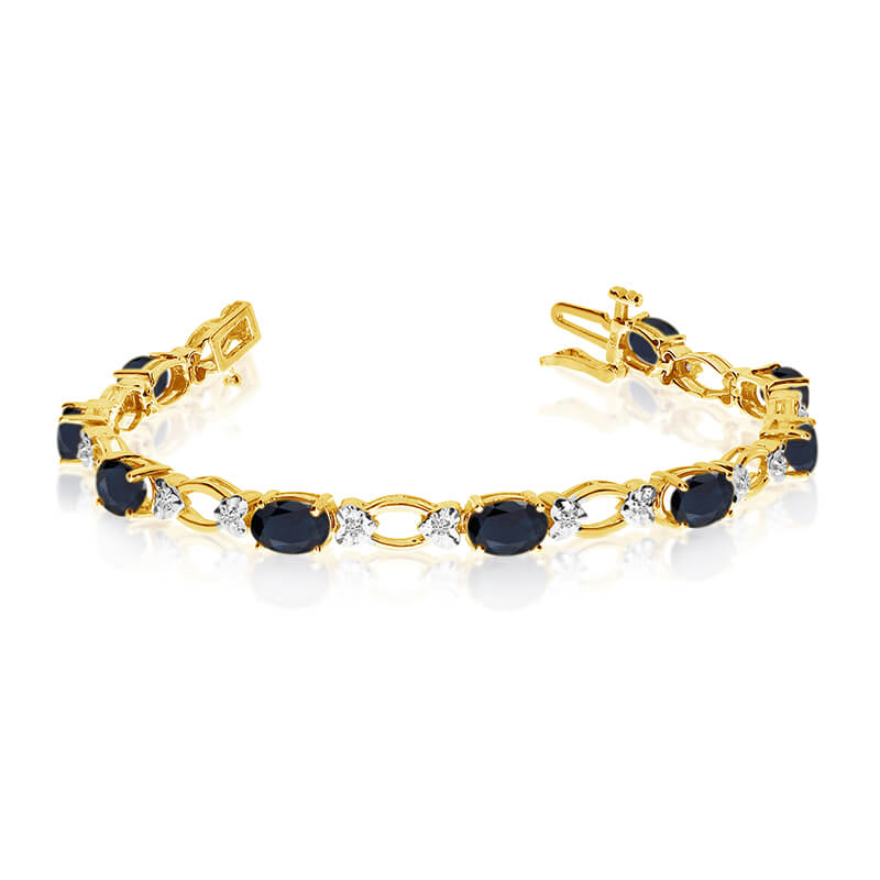 This 14k yellow gold natural sapphire and diamond tennis bracelet features 12 oval sapphires with...