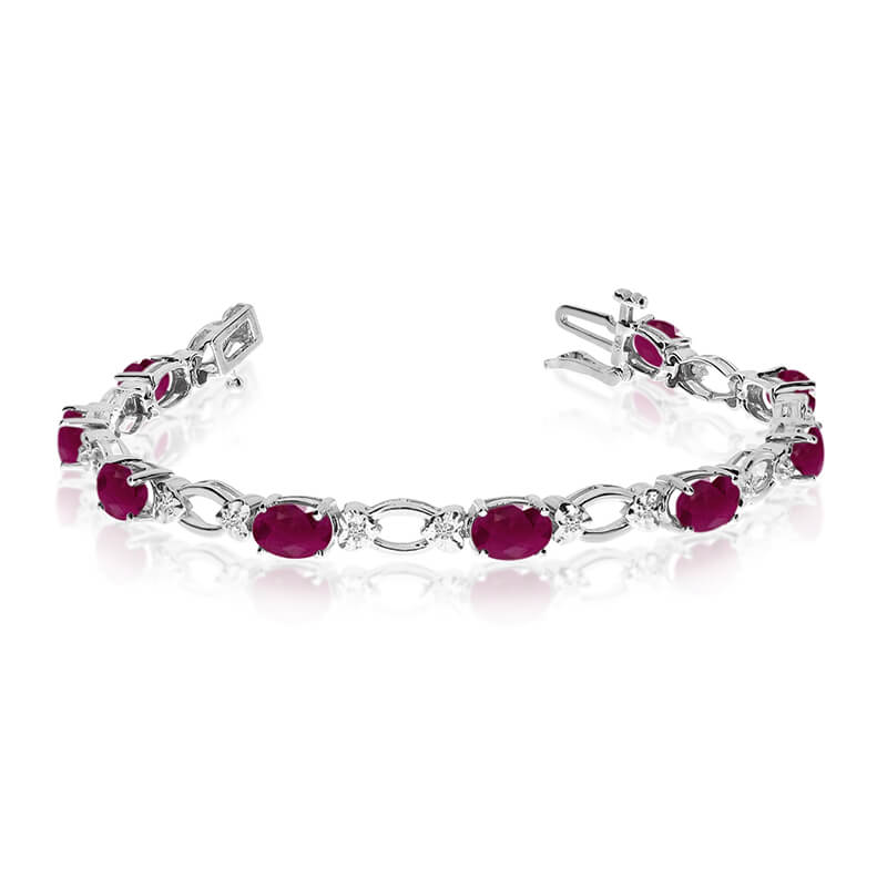 This 14k white gold natural ruby and diamond tennis bracelet features 12 oval rubys with a total ...