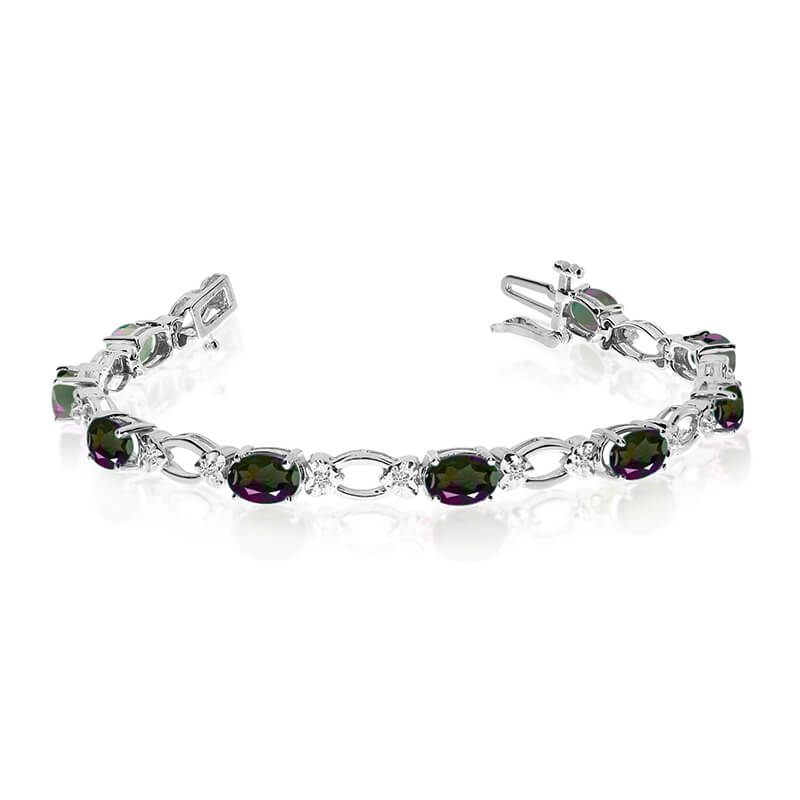 This 14k white gold natural mystic topaz and diamond tennis bracelet features 12 oval all natural...