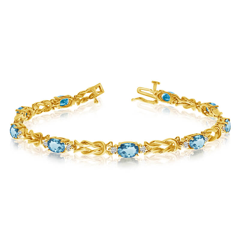 This 14k yellow gold natural aquamarine and diamond tennis bracelet features 9 oval aquamarines w...