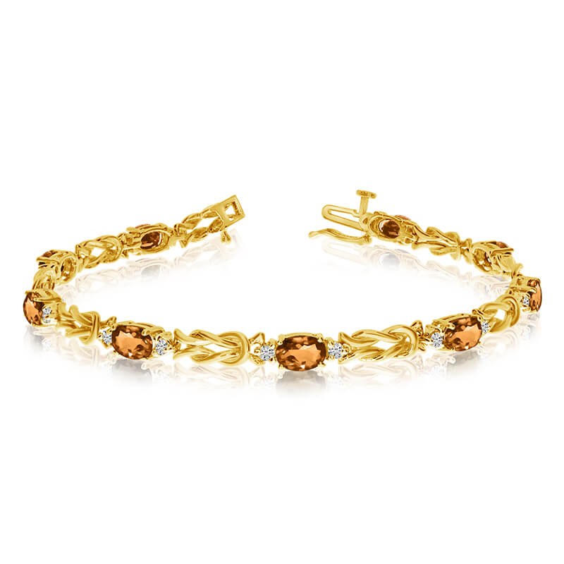 This 14k yellow gold natural citrine and diamond tennis bracelet features 9 oval citrines with a ...