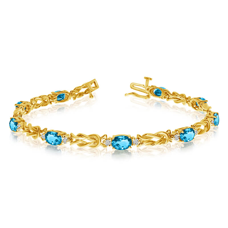 This 14k yellow gold natural blue-topaz and diamond tennis bracelet features 9 oval blue-topazs w...
