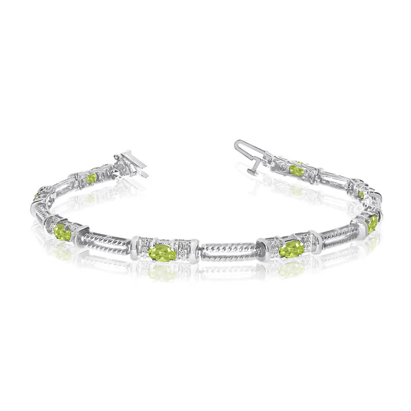 This 14k white gold natural peridot and diamond tennis bracelet features 8 oval peridots with a t...