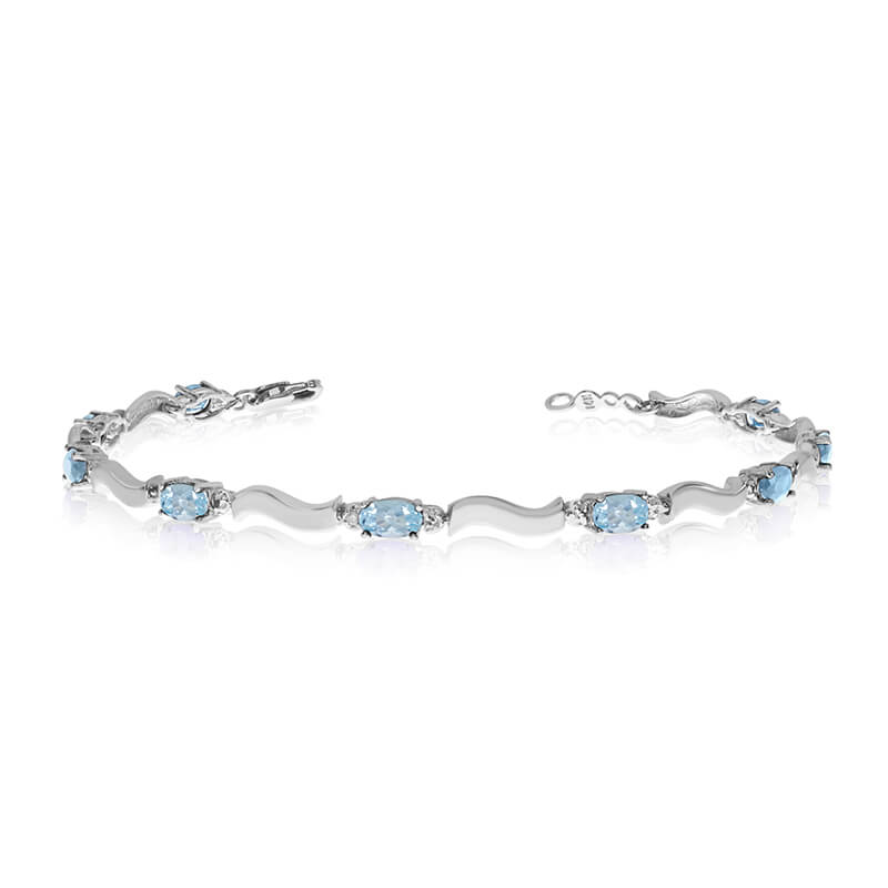 This 10K White Gold oval aquamarine and diamond bracelet features nine 5x3 mm stunning natural aq...