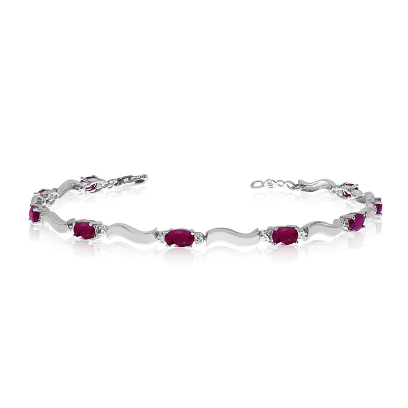 This 10K White Gold oval ruby and diamond bracelet features nine 5x3 mm stunning natural ruby sto...