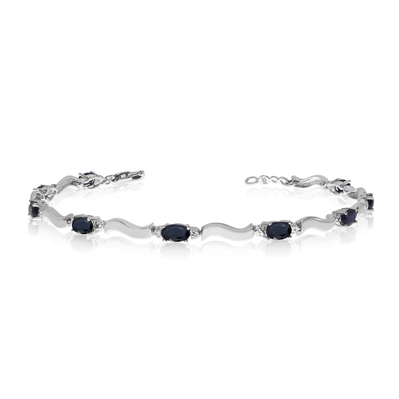 This 10K White Gold oval sapphire and diamond bracelet features nine 5x3 mm stunning natural sapp...