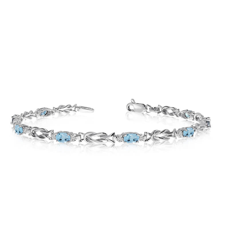 This 10K White Gold oval aquamarine and diamond bracelet features eight 5x3 mm stunning natural a...