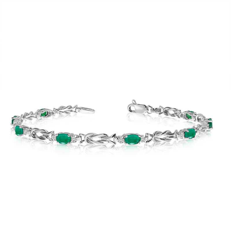 This 10K White Gold oval emerald and diamond bracelet features eight 5x3 mm stunning natural emer...
