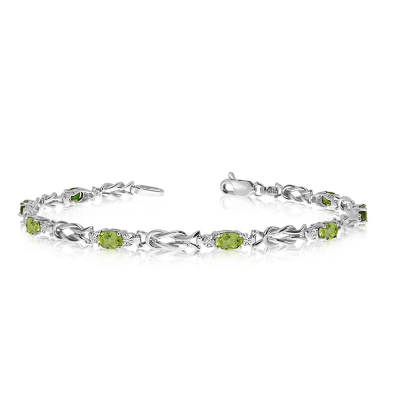 This 10K White Gold oval peridot and diamond bracelet features eight 5x3 mm stunning natural peri...