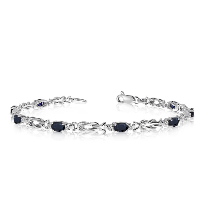 This 10K White Gold oval sapphire and diamond bracelet features eight 5x3 mm stunning natural sap...
