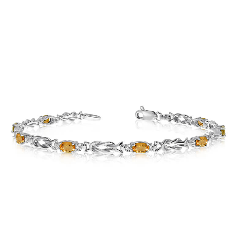This 10K White Gold oval citrine and diamond bracelet features eight 5x3 mm stunning natural citr...