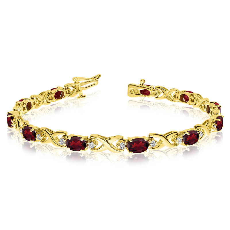 This 14k yellow gold natural garnet and diamond tennis bracelet features 11 oval garnets with a t...