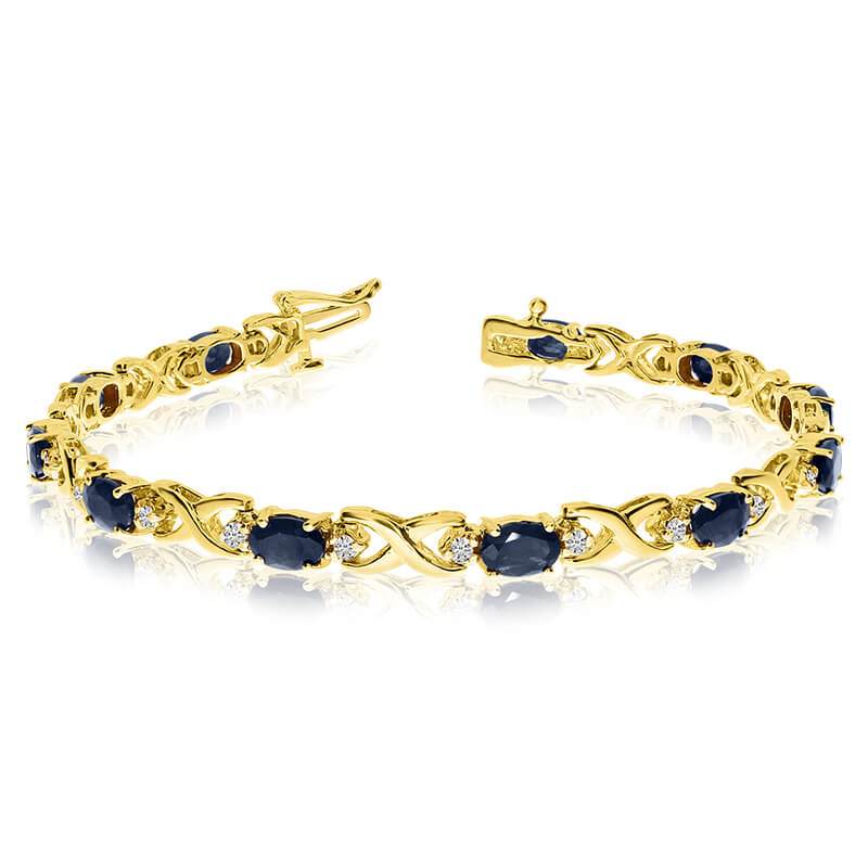 This 14k yellow gold natural sapphire and diamond tennis bracelet features 11 oval sapphires with...