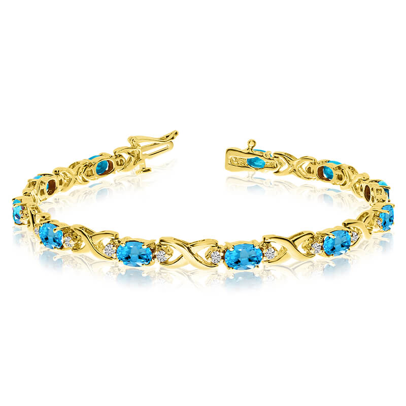 This 14k yellow gold natural blue-topaz and diamond tennis bracelet features 11 oval blue-topazs ...