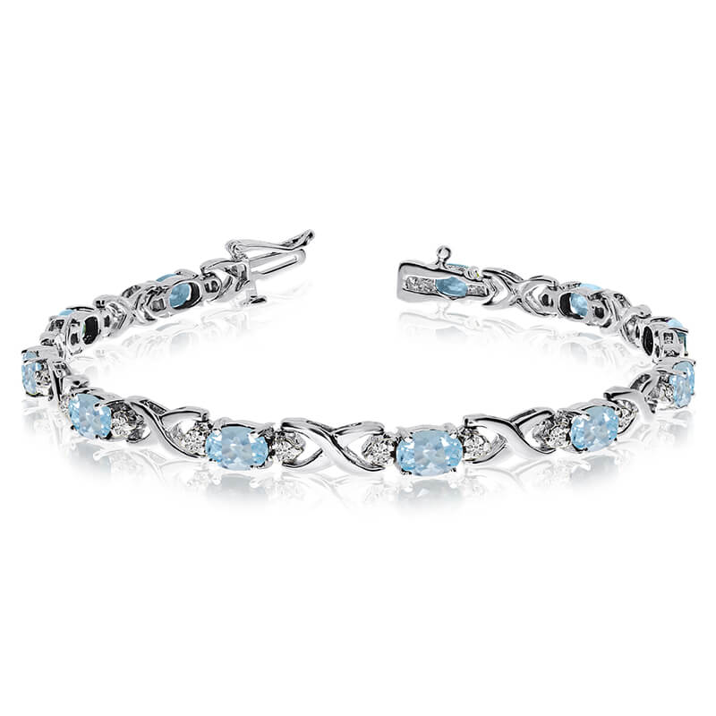 This 14k white gold natural aquamarine and diamond tennis bracelet features 11 oval aquamarines w...
