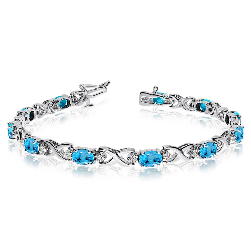 This 14k white gold natural blue-topaz and diamond tennis bracelet features 11 oval blue-topazs w...