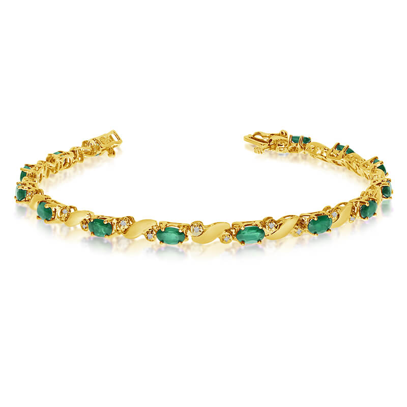 This 14k yellow gold natural emerald and diamond tennis bracelet features 13 oval emeralds with a...