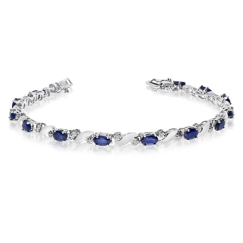 This 14k white gold natural sapphire and diamond tennis bracelet features 13 oval sapphires with ...