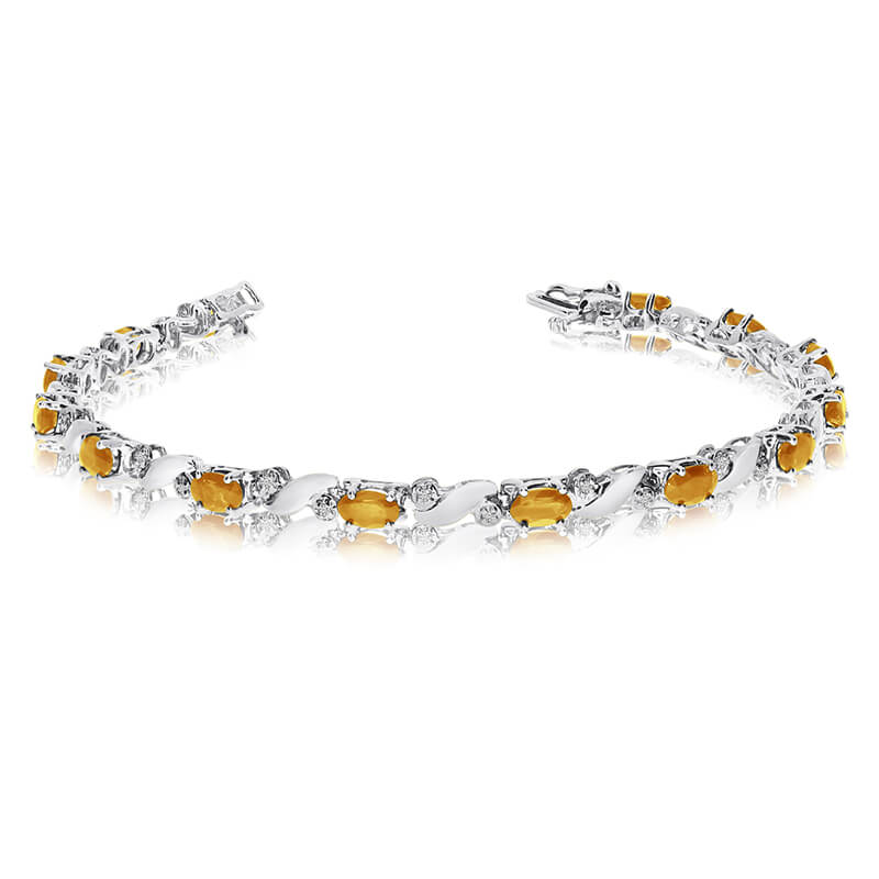 This 14k white gold natural citrine and diamond tennis bracelet features 13 oval citrines with a ...